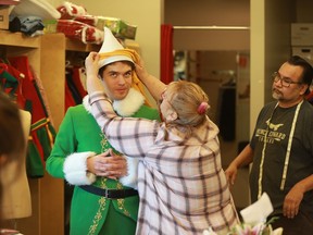 Bonnie Deakin helps fit the classic green Elf costume onto lead actor Felix LeBlanc during a costume fitting for Persephone Theatre's production of Elf: The Musical, which opens on Dec. 6, 2019.