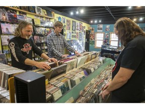 From left to right, Darren McKay and Darrin O'Grady flip though records at Vinyl Diner. The two jointly purchased the diner from Stewart 'Stu' Cousins, who owned the business for 24 years.