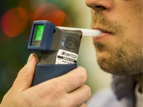 Scott McGregor, SGI Communications Consultant, tests out an approved screening device for alcohol, commonly referred to as a breathalyzer, at a demonstration on the tools the Saskatoon Police Service is using to combat impaired driving. Photo taken in Saskatoon, on Dec. 9, 2019.