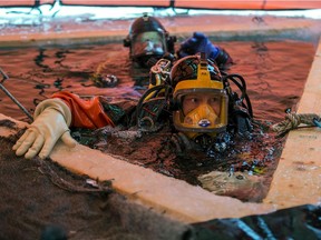 Saskatoon Firefighter Jeremy Winter is pictured in the water prior to diving under the ice during ice dive training on Blackstrap Lake.