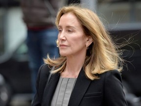 Actress Felicity Huffman is escorted by Police into court where she is expected to plead guilty to one count of conspiracy to commit mail fraud and honest services mail fraud before Judge Talwani at John Joseph Moakley United States Courthouse in Boston, Massachusetts, May 13, 2019.