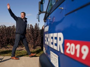 Conservative leader Andrew Scheer waves to supporters after canvassing a neighbourhood with local candidate Michael Kram in Regina on Oct. 21, 2019.