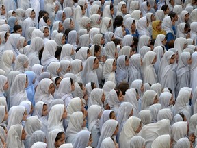 This photograph taken on June 21, 2013 shows Pakistani girls gathered for school assembly before attending their respective classes in Mingora, the main town of Swat valley, Pakistan. More than 600 girls and women have been found to be trafficked as brides in China.