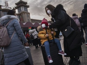 A girl wears a protective mask at Beijing Railway station before the annual Spring Festival Jan. 21, 2020 in Beijing, China. The number of cases of a deadly new coronavirus keep rising.