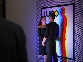 Lisa Langan (L) and Brian March (R) stand in a photo booth at the Remai Modern during LUGO, a fundraiser for the Remai Modern in Saskatoon, SK on Saturday, January 13, 2018.