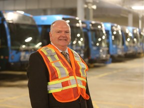 Jim McDonald, director of Saskatoon Transit, stands with city buses in the civic operations centre on Dec. 6, 2018.