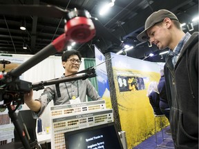 Seungbum Steve Ryu (left), a research technician from the University of Saskatchewan, speaks with Jordan Wallman about the use of drones in agriculture at the Crop Production Show at Prairieland Park in Saskatoon, SK. on Wednesday, Jan. 16, 2019.
