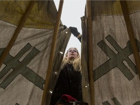 Katie Willie, an archeology interpretive guide at Wanuskewin, helps put up a teepee near Victoria School to host storytelling which will be used during the Winterruption festival on Jan. 22, 2019.