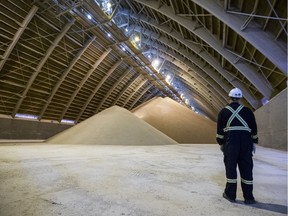In this 2019 file photo Nutrien employee Rob Staudinger stands in a potash holding facility during a media tour at the Nutrien Cory Mine.