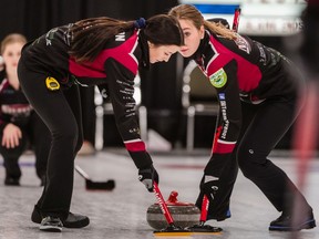 Rachel Erickson and Paige Engel sweep during Team Thevenot's provincial-championship victory.