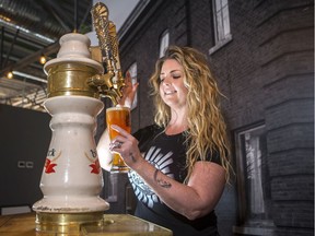 Heather Williams, owner of Prairie Sun, pours a beer from a tap that was in the original Lydia's bar, in the upstairs of her bar in Saskatoon on Jan. 22, 2020. The tap also poured the first craft beer Williams ever drank.