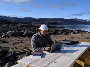David Lawson, student at the Nunavut Law School, studies while out at his cabin.