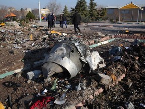Rescue teams work amidst debris after a Ukrainian plane carrying 176 passengers crashed near Imam Khomeini airport in the Iranian capital Tehran early in the morning on Jan. 8, 2020, killing everyone on board.
