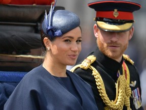 In this file photo taken on June 08, 2019 Britain's Meghan, Duchess of Sussex (L) and Britain's Prince Harry, Duke of Sussex (R) return to Buckingham Palace after the Queen's Birthday Parade, 'Trooping the Colour', in London.