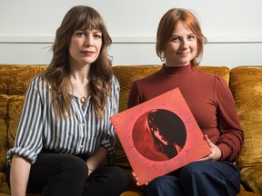 Musician Belle Plaine (Melanie Berglund), left, and artist Terri Fidelak sit together at Silt Studio, holding a copy of Belle Plaine's record Malice, Mercy, Grief & Wrath. It was nominated for album artwork of the year for the 2020 Juno Awards.
