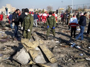 Security officers and Red Crescent workers are seen at the site where the Ukraine International Airlines plane crashed after take-off from Iran's Imam Khomeini airport, on the outskirts of Tehran, Iran January 8, 2020. Nazanin Tabatabaee/WANA (West Asia News Agency) via REUTERS