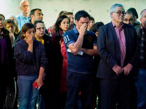 Attendees wipe away tears during a memorial service at Western University in London, Ontario on January 8, 2020 for the four graduate students who were killed in a plane crash in Iran.