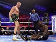 Tyson Fury, left, knocks down Deontay Wilder in the fifth round during their Heavyweight bout for Wilder's WBC and Fury's lineal heavyweight title on Feb. 22, 2020 at MGM Grand Garden Arena in Las Vegas, Nevada. (Al Bello/Getty Images)