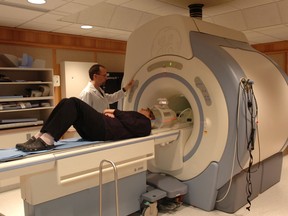 A Regina General Hospital MRI technicians is pictured with an MRI unit.