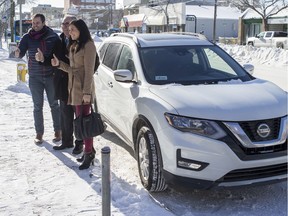From left to right, Michael van Hemmen, Uber's business manager, Joe Hargrave, Minister responsible for Saskatchewan Government Insurance (SGI), and Michelle Okere, regional manager of Saskatchewan and Manitoba for MADD Canada, stand for a photo after the first Uber ride outside city hall during a media event in Saskatoon on Tuesday, February 5, 2019.
