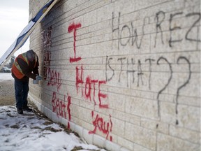 Darrel Treppel of Gorilla Property Services removes graffiti from the exterior of the First Nations University building in Regina on Friday, Feb. 14, 2020.