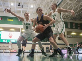 University of Saskatchewan Huskies guard Claudia Lomba Viana.left, and forward Summer Masikewich, right, battle for the ball with University of Victoria Vikes guard Morgan Roskelley during Canada West womenÕs basketball quarterfinal playoff action at the PAC on the U of S campus in Saskatoon, SK on Thursday, February 20, 2020.