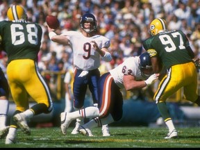 Quarterback Jim McMahon of the Chicago Bears (center) looks to pass against the Green Bay Packers during a 1988 game. McMahon will be the guest speaker at this year's Huskies Dogs' Breakfast.