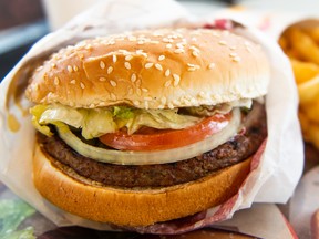 In this photo illustration, an 'Impossible Whopper' sits on a table at a Burger King restaurant on April 1, 2019 in Richmond Heights, Missouri.