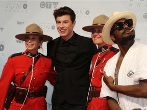 Three-time JUNO winner K-OS photo bombs JUNO nominee and performer Shawn Mendes walks on the red carpet at the 2016 Juno Awards at the Saddledome in Calgary, Alta., on Sunday, April 3, 2016.  GAVIN YOUNG/POSTMEDIA ORG XMIT: POS1604031631330867