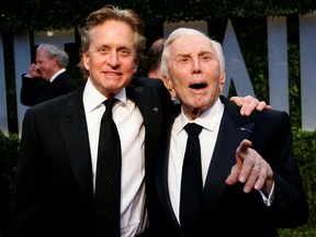 FILE PHOTO: Actor Michael Douglas (L) and his father, actor Kirk Douglas, arrive together at the 2009 Vanity Fair Oscar Party in West Hollywood, California February 22, 2009. REUTERS/Danny Moloshok/File Photo