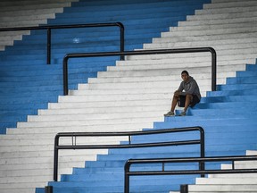 A ballboy waits in the empty stands of Presidente Peron Stadium prior to a Group F match between Racing Club and Alianza Lima as part of Copa CONMEBOL Libertadores 2020 at Presidente Peron Stadium on March 12, 2020 in Avellaneda, Argentina.
