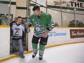 SASKATOON, SASK--MARCH 5 2016 0307 Sports Huskies Men Hockey- University of Saskatchewan Huskies forward Kohl Bauml brings his brother on to the ice to celebrate after defeating the University of Alberta Golden Bears to win the CIS Men's Hockey Canada West championship on Saturday, March 5th, 2016.