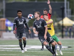 Brendan McDonough with Vancouver Whitecaps U-23 heads the ball away from Nikolas Baikas of the SK Selects all-star squad during a SK Summer Series friendly soccer match in Saskatoon, SK on Thursday, July 25, 2019.