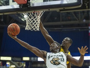 Saskatchewan Rattlers forward Shaquille Keith {13} attempts a shot while under the basket to avoid an Edmonton Stinger defender during CEBL championship weekend playoff action in Saskatoon on Saturday, August 23, 2019. (Saskatoon StarPhoenix/Rick Elvin)