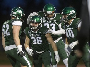 The University of Saskatchewan Huskies celebrate a play against the Calgary Dinos during action at Griffiths Stadium this past season.