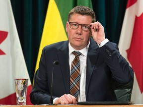 Saskatchewan Premier Scott Moe adjusts his glasses while taking questions from members of the media to give an update on the province's response to COVID-19. The news conference was held at the Saskatchewan Legislative Building in Regina, Saskatchewan on Mar. 13, 2020.