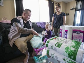 Shane Dankoski, his daughet Jaida and wife Alesia have handed out more than 200 rolls of toilet paper in the bast weekend. (Saskatoon StarPhoenix/Matt Smith)