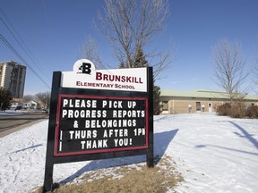 A sign outside of Brunskill School asks parents to pick up their children's belongings by Thursday. The province has announced that schools will close indefinitely as of Friday, March 20, 2020. Photo taken in Saskatoon, SK on Tuesday, March 17, 2020.