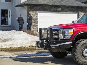 Members of the Warman Fire Department deliver a birthday package to Sloan Hanson, who is celebrating her ninth birthday. Sloan's brother Harper Hanson looks on.