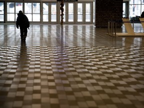 A man walks through a nearly deserted Convention Centre in Montreal on Thursday, March 19, 2020.