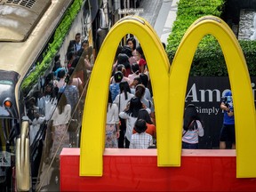Chinese tourists board their bus in front of a McDonald's restaurant in Bangkok on January 30, 2020.