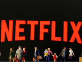 Small toy figures are seen in front of diplayed Netflix logo in this illustration taken March 19, 2020. REUTERS/Dado Ruvic/Illustration