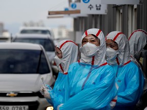 Medical staff in protective gear work at a 'drive-thru' testing centre for the novel coronavirus disease of COVID-19 in Yeungnam University Medical Center in Daegu, South Korea, March 3, 2020.
