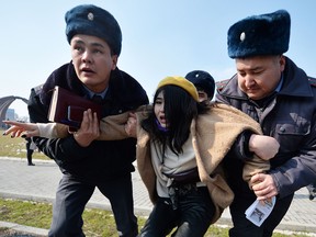 Kyrgyz police arrest a woman protesting against gender-based violence to mark International Women's Day in Bishkek on March 8, 2020.