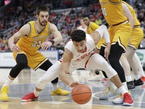 Bradley's Ja'Shon Henry, right, and Valparaiso's John Kiser (33) reach for the ball during the first half of an NCAA college basketball game in the championship of the Missouri Valley Conference men's tournament on March 8 in St. Louis.