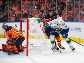 Colby Cave #12 of the Edmonton Oilers battles behind the net with Bo Horvat #53 of the Vancouver Canucks at Rogers Place on October 2, 2019, in Edmonton, Canada.
Photo by Codie McLachlan/Getty Images