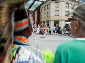 Indigenous dancers and members of the audience dance together to close out a display by the Charging Bear Pow Wow group in City Square Plaza during a National Indigenous Peoples Day event in 2018.