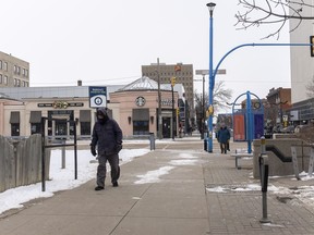 People walk 2nd Avenue South in Saskatoon, SK on Wednesday, April 1, 2020.