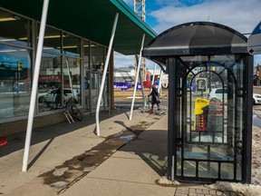 A woman returns a shopping cart to the Extra Foods on Broadway Avenue.