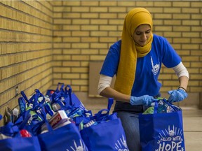 Nisa Bano, regional coordinator for Saskatchewan for Islamic Relief Canada, packs essential hygiene and sanitation products into a bag. IRC, in partnership with the Islamic Association of Saskatchewan, is putting together kits for the elderly, vulnerable families, and those who are immuno-compromised